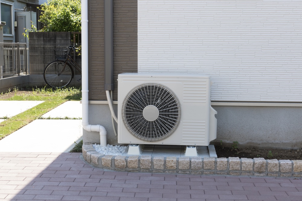 Heat Pump outside of house in summer